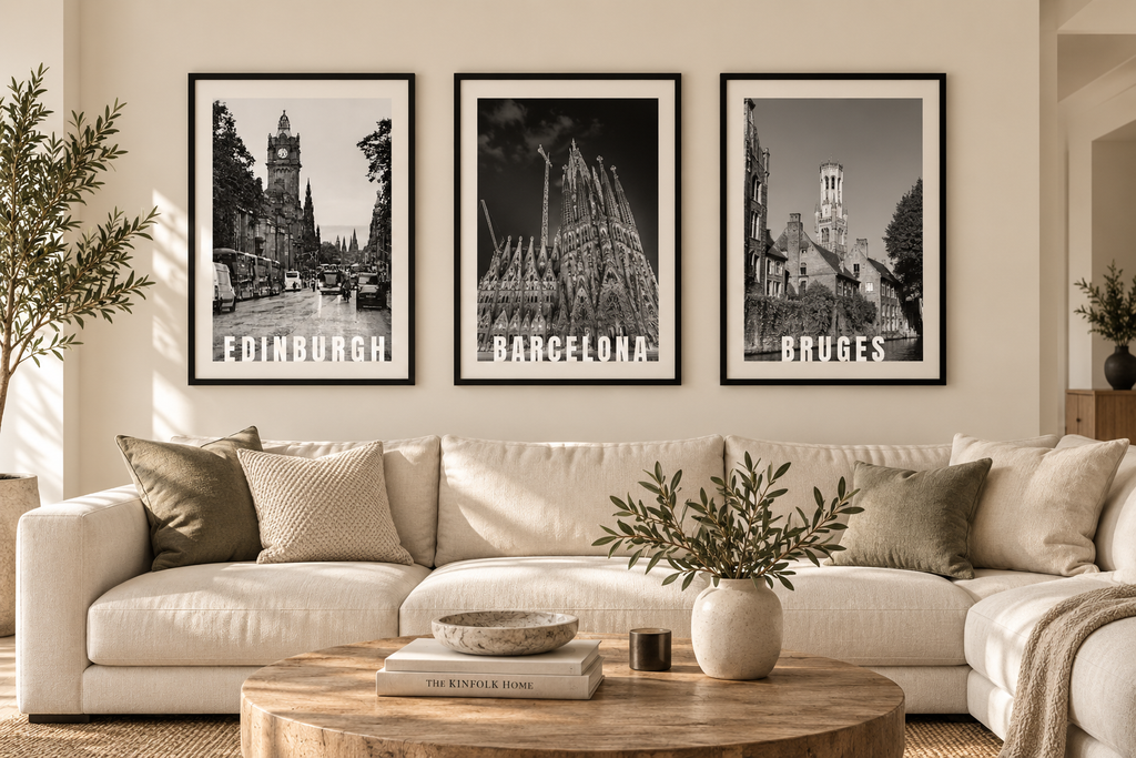 Framed Edinburgh, Barcelona and Bruges city prints above a sofa